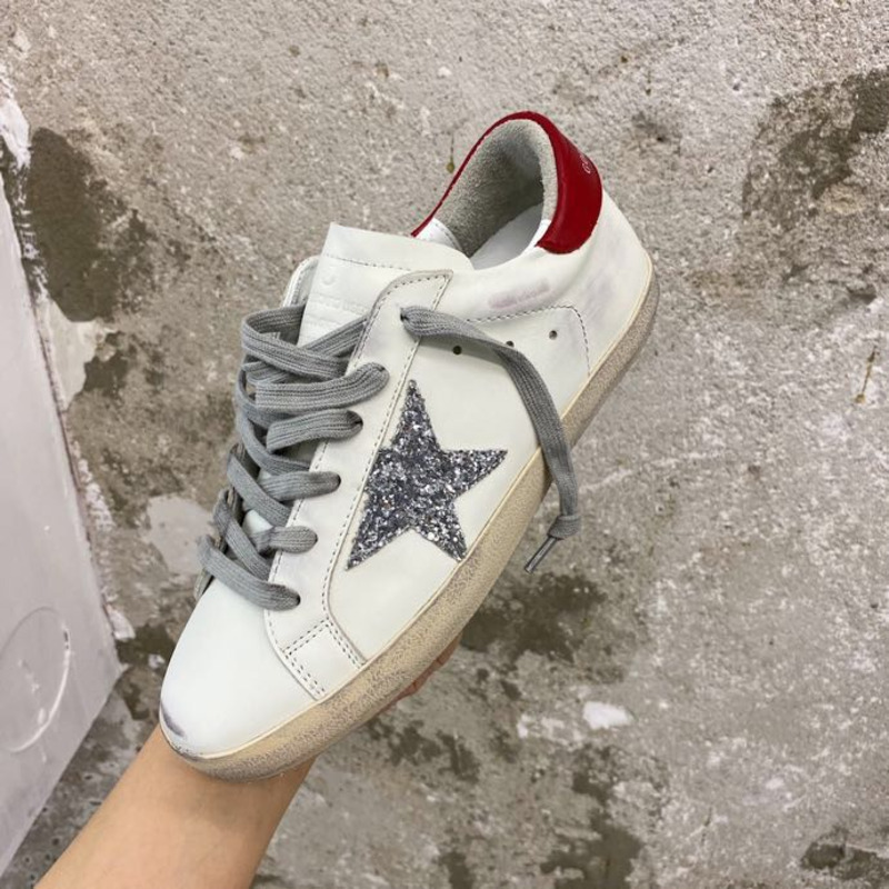 golden goose S*per-star sneakers with sliver glitter and red heel tab