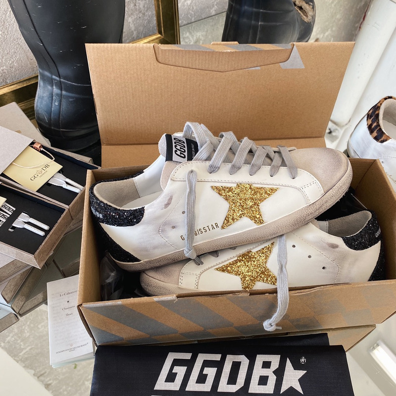 golden goose S*per-star sneakers with golden glitter and black heel tab
