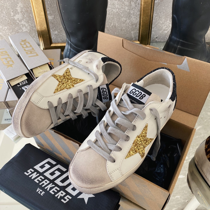 golden goose S*per-star sneakers with golden glitter and black heel tab