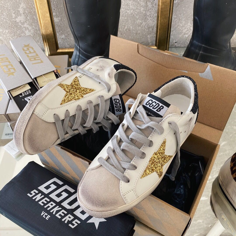 golden goose men’s S*per-star sneakers with golden glitter and black heel tab