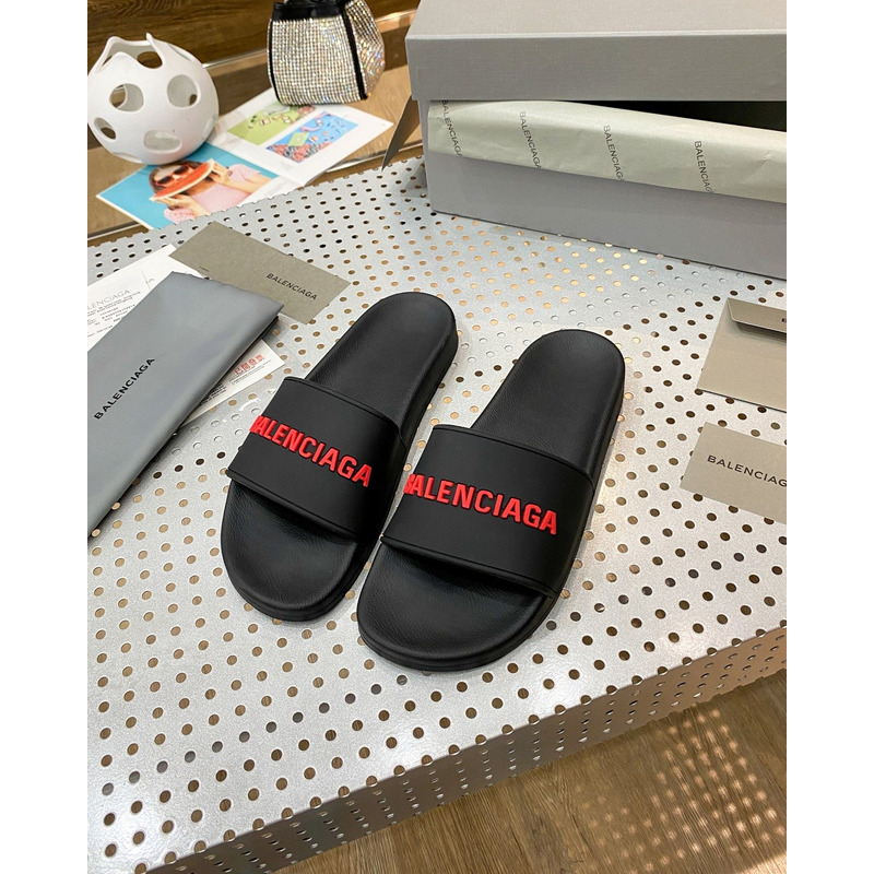 Ba*len*cia*ga pool slide sandal in black rubber with red 3d Ba*len*cia*ga logo