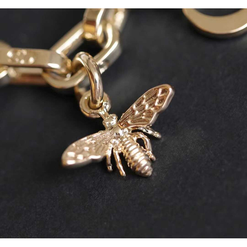 D*or montaingne bag charm gold-finish metal and white resin pearls with black and ethereal pink lacquer