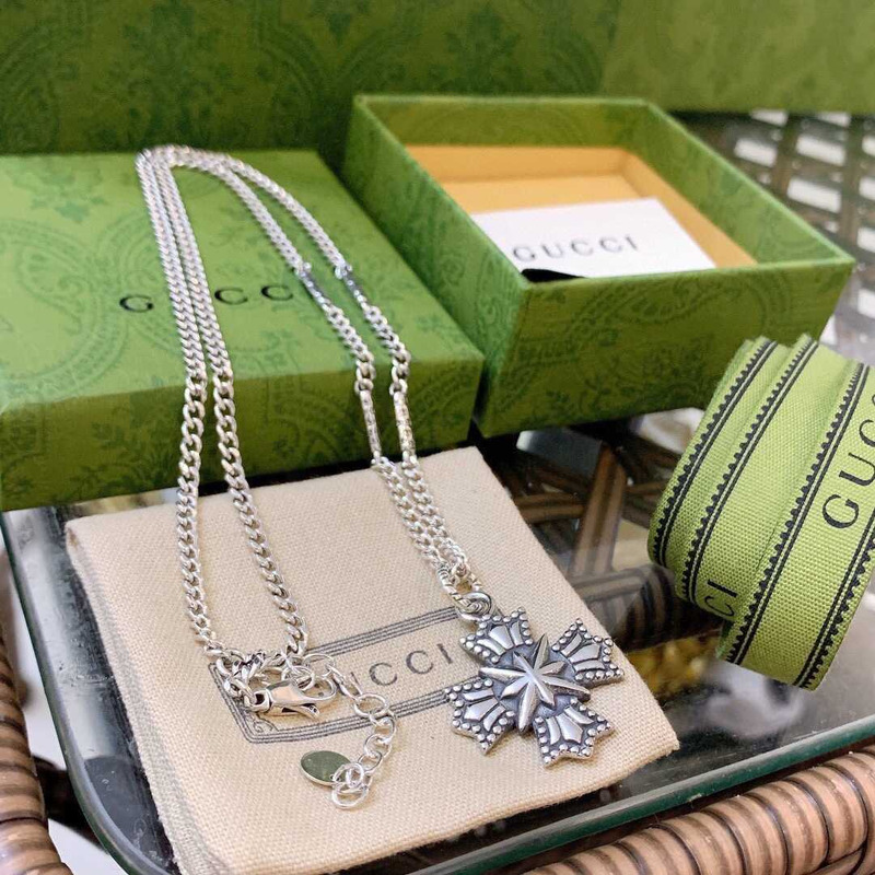 G*u*i crucifixion necklace