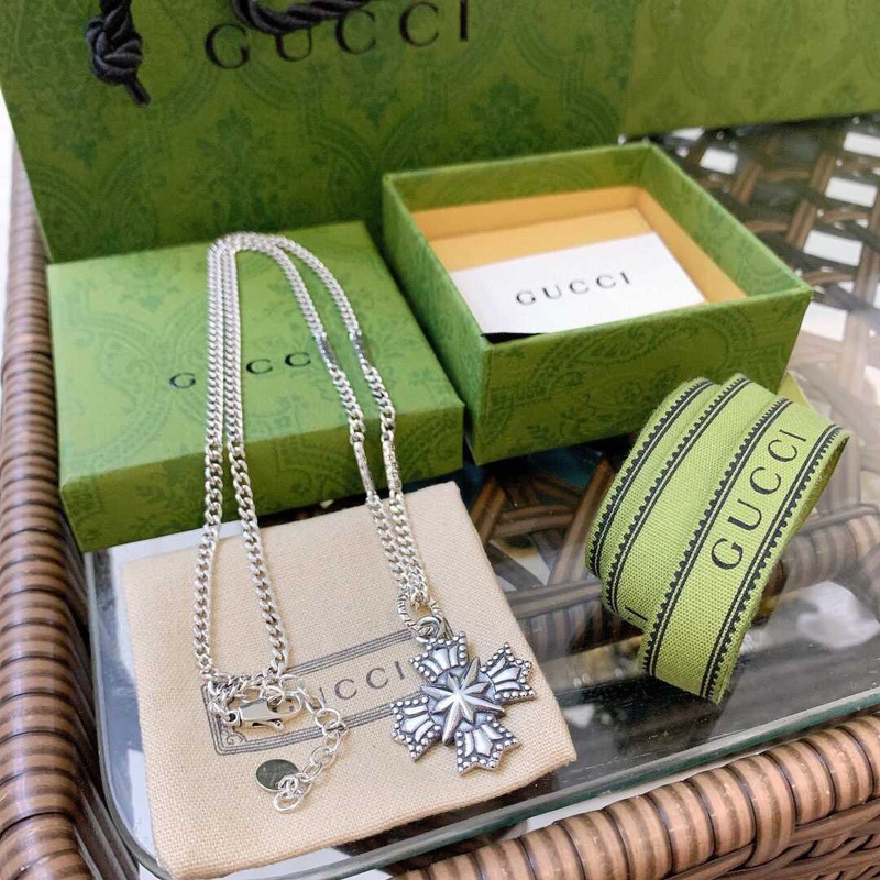 G*u*i crucifixion necklace