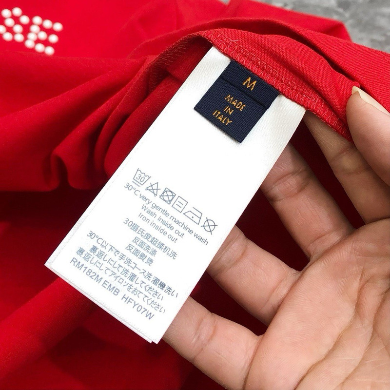 l**is V*t*n t-shirt red calligraphy and a violin case