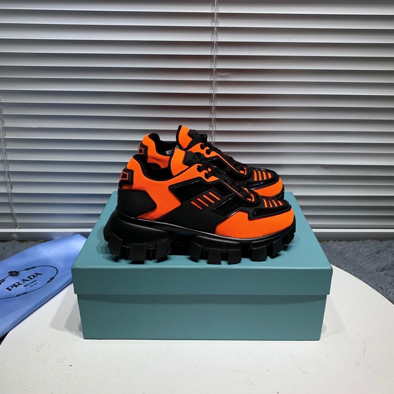 Pra*a cloudbust thunder knit sneakers in black/orange