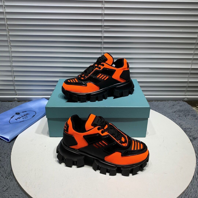 Pra*a cloudbust thunder knit sneakers in black/orange