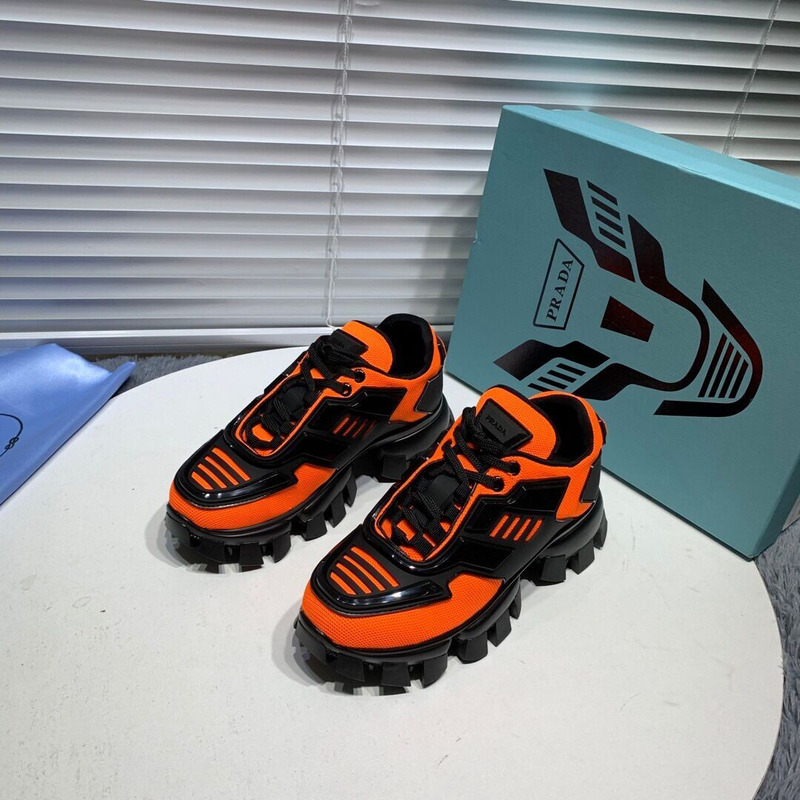 Pra*a cloudbust thunder knit sneakers in black/orange