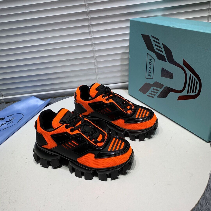 Pra*a cloudbust thunder knit sneakers in black/orange